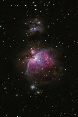 A stunning long-exposure photograph of the Orion Nebula and surrounding star cluster.