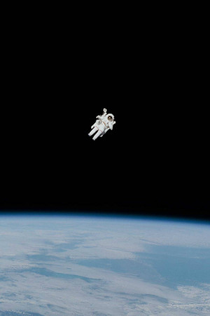 An astronaut floating in space with Earth in the background
