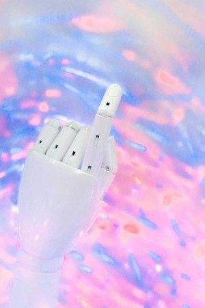 A white robotic hand giving the middle finger against a colorful abstract background.
