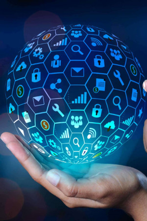 A hand holding a glowing globe covered in digital icons representing technology and connectivity.