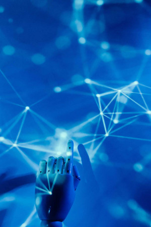 A robotic hand reaching towards a network of glowing lines and dots, representing artificial intelligence and connectivity.