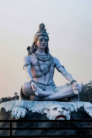 A large statue of Lord Shiva meditating in a lotus position.