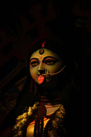 Close-up portrait of Goddess Kali with a dark complexion and striking features.