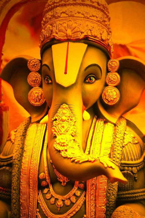 Close-up of a golden statue of Lord Ganesha
