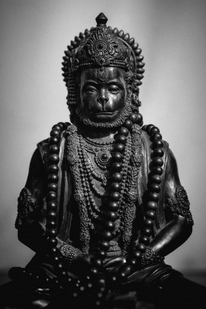 Close-up of a detailed black stone statue of Hanuman, the Hindu monkey god.