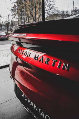 Close-up of a red Aston Martin Vantage rear with the logo and 'Advantage' text visible.