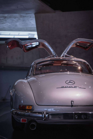 Rear view of a classic silver Mercedes-Benz 300SL Gullwing with doors open