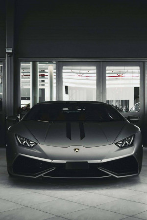 Front view of a matte gray Lamborghini parked indoors