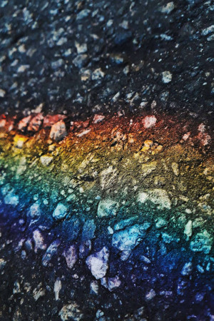 Close-up of asphalt with rainbow colored streaks