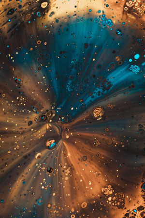 Close-up abstract image of colorful water droplets creating a burst effect.