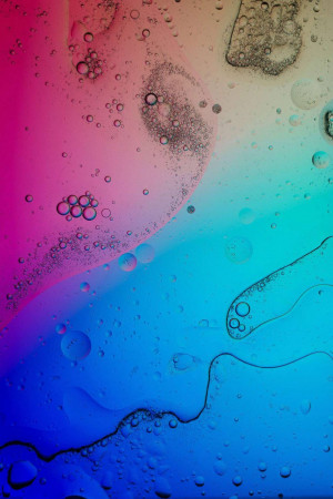 Close-up of colorful oil and water droplets creating an abstract pattern.