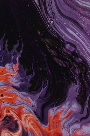 Close-up of abstract fluid acrylic paint swirls in purple, orange, and black.
