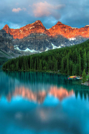 Stunning view of Moraine Lake with mountains illuminated by sunrise