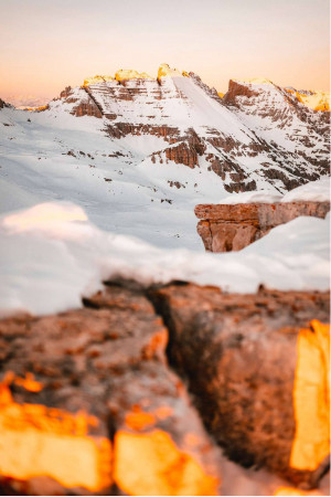 Snow-capped mountains illuminated by the golden light of sunset