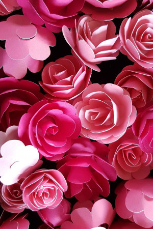 Close-up of a wall covered in pink paper roses