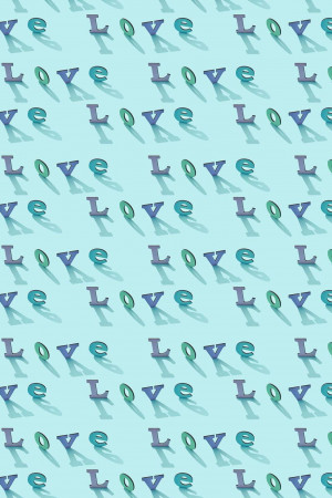Repeating pattern of the word 'Love' in various shades of blue and green.