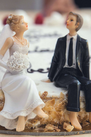 Close-up of a bride and groom cake topper looking at each other