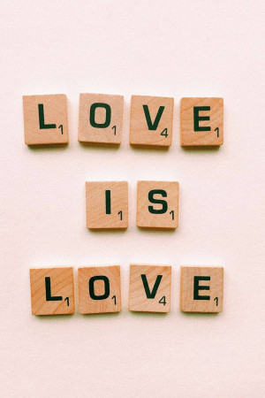 Wooden Scrabble tiles spelling out 'Love is Love'