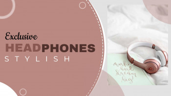 Pink headphones on a bed with a notebook