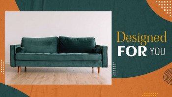 A modern teal velvet sofa in a bright living room setting.