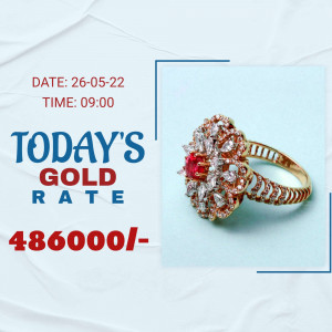 Close-up of a ruby and diamond gold ring with today's gold rate displayed