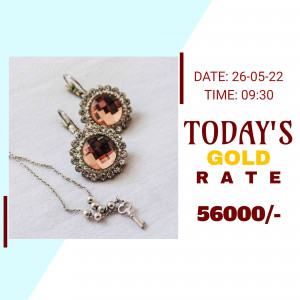 Close-up of gold earrings and necklace with gold rate information