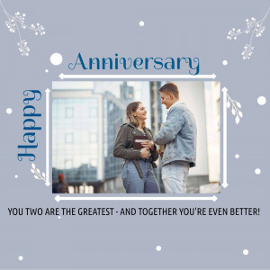 A couple embracing in front of a city background with anniversary wishes.