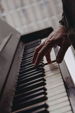 Close-up of hands playing a piano