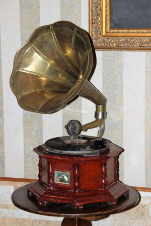 Antique brass gramophone with a wooden base