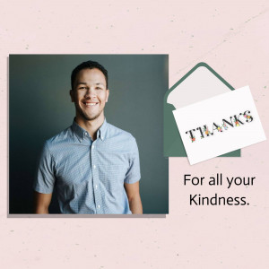 A man smiling next to a thank you card.