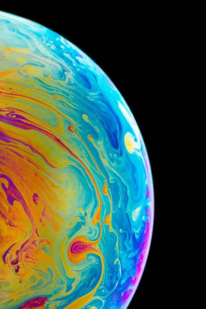 Close-up of a soap bubble with vibrant swirling colors