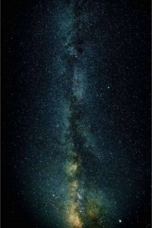 A stunning vertical view of the Milky Way galaxy stretching across a dark night sky.
