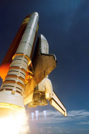 A space shuttle launching into the night sky with bright flames and smoke.