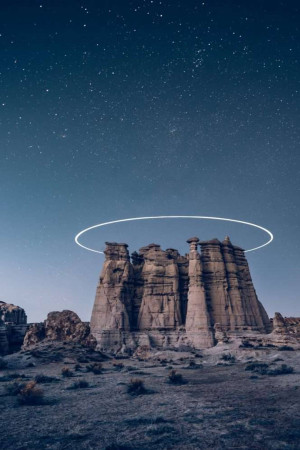 Dramatic landscape of hoodoos rock formations under a starry night sky