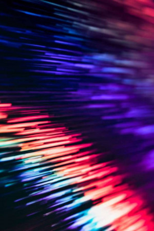 Abstract image of colorful light trails in a dark background