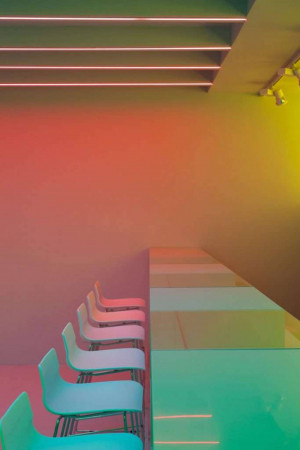 Modern interior with neon lighting and minimalist chairs