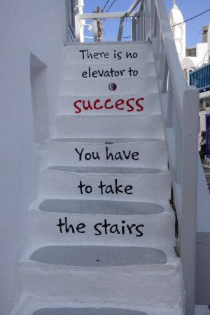 White stairs with motivational text painted on them.