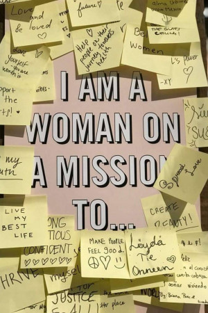 A wall covered in sticky notes with empowering messages and the phrase 'I AM A WOMAN ON A MISSION' prominently displayed.