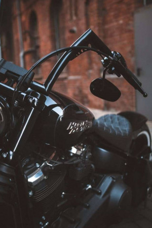 Close-up of a black Harley Davidson motorcycle handlebar and fuel tank
