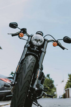 Close-up of a black motorcycle's front end with a blurred background.