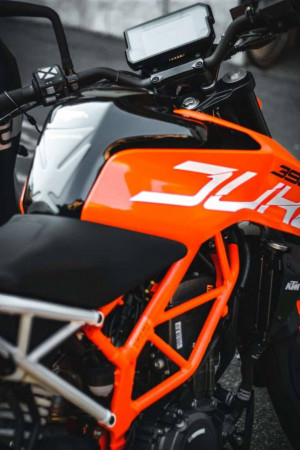 Close-up of an orange and black KTM 390 Duke motorcycle