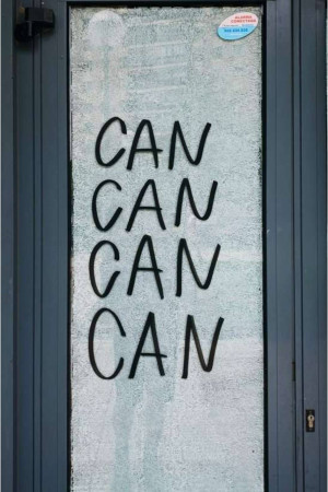 Graffiti of the word 'CAN' repeated four times on a glass door.