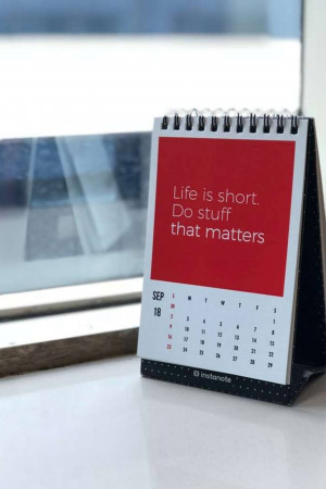 A desk calendar displaying a motivational quote and the month of September.