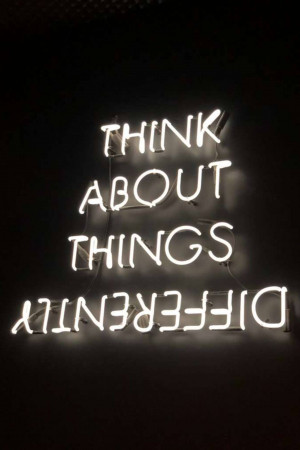Neon sign with the words 'Think About Things Differently'