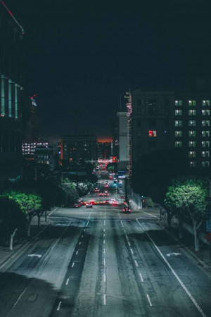 A long exposure shot of a city street at night with blurred car lights.
