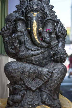 Close-up of a dark stone statue of Lord Ganesha