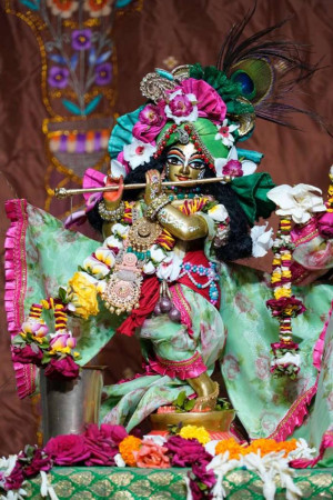A beautifully decorated idol of Lord Krishna playing a flute.
