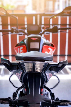Close-up of a black and orange KTM Duke motorcycle's front end