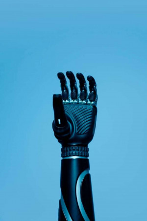 Close-up of a black robotic hand against a blue background