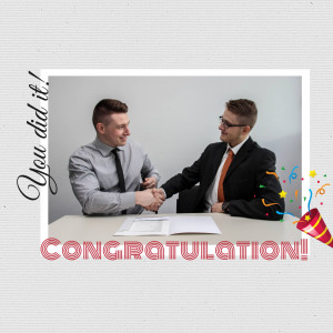 Two men shaking hands over a table with confetti and celebratory text.